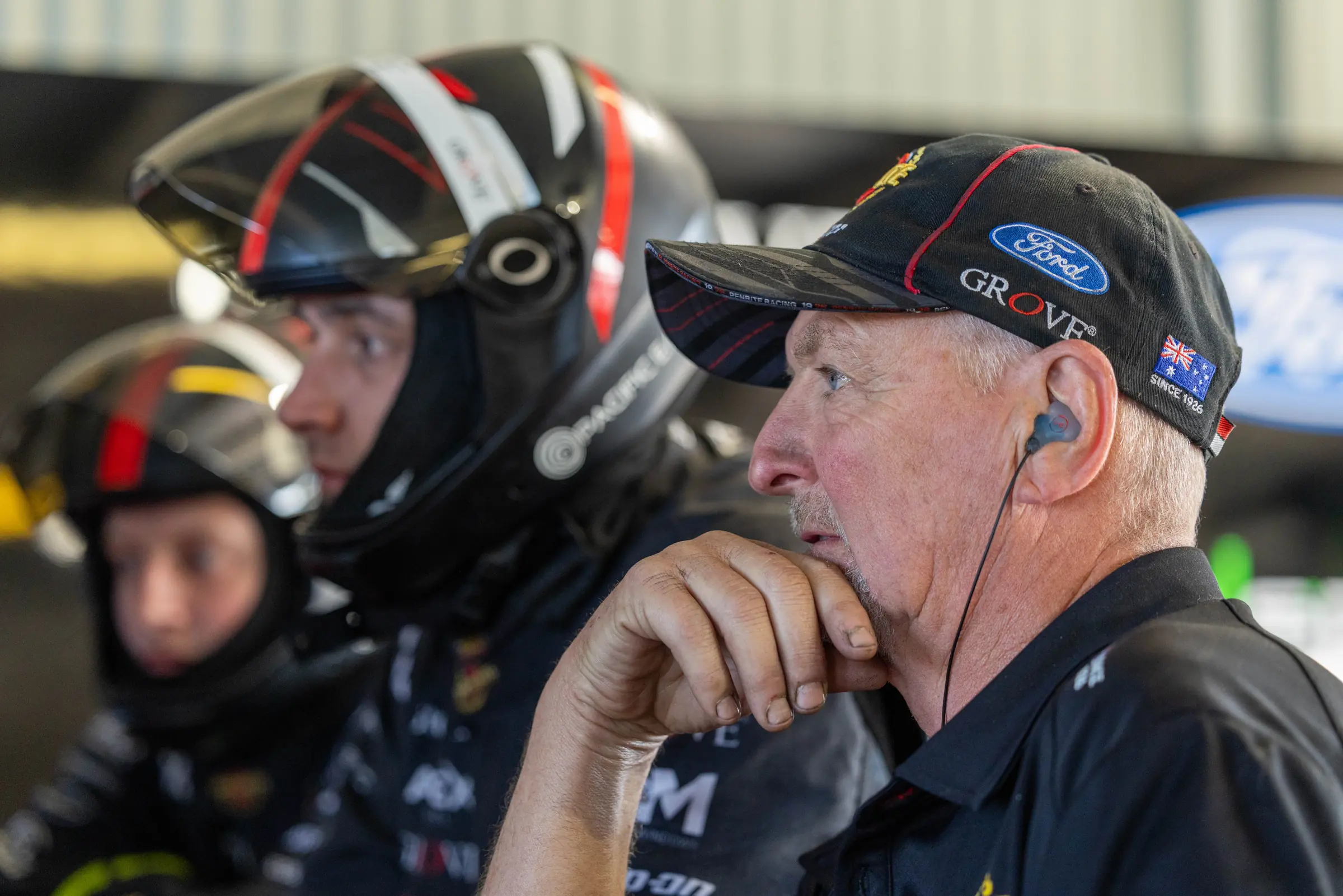 Motorsport pit crew team using in-ear communications during race operations