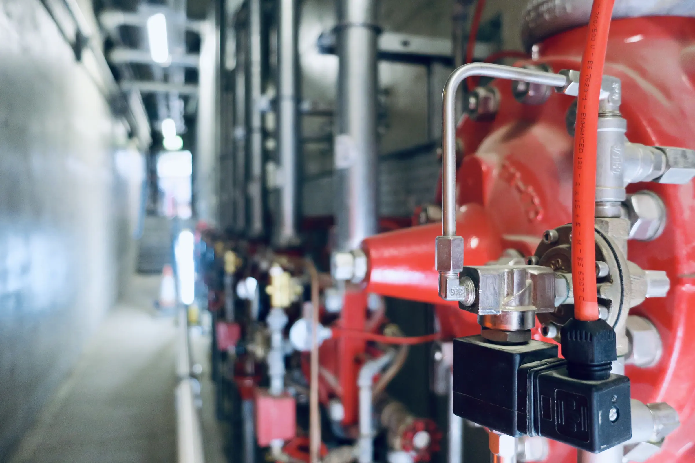 Industrial pipes and valves in a high-noise work environment