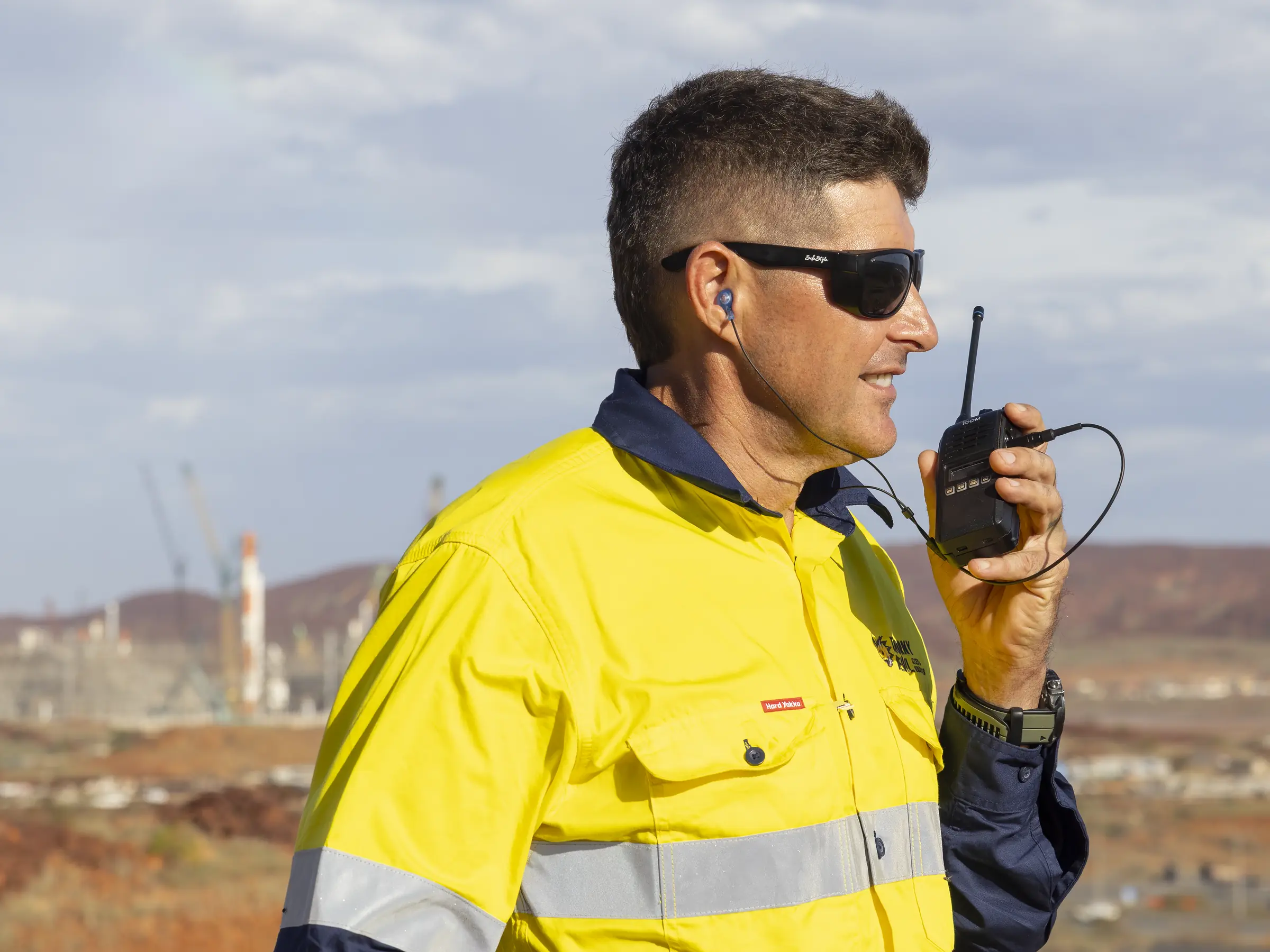 Two-way radio connected to custom in-ear communication equipment